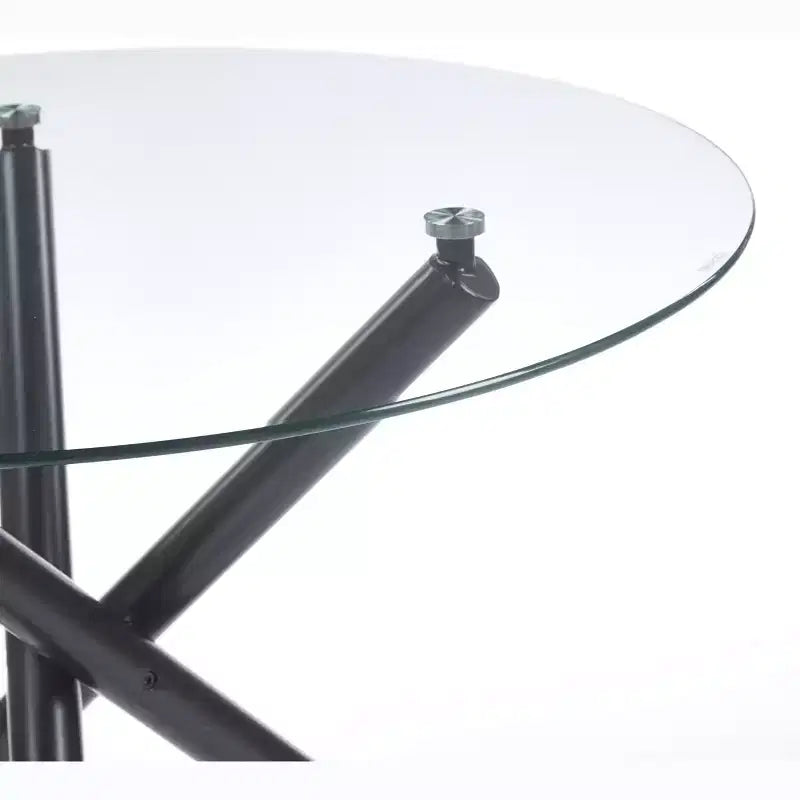 Table à manger ronde avec pied en métal noir et plateau en verre trempé, design moderne peu encombrant pour cuisine ou salon
