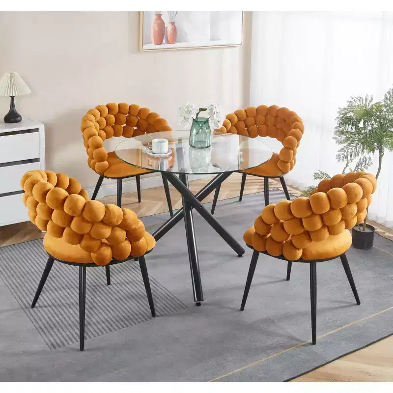 Table à manger ronde avec pied en métal noir et plateau en verre trempé, design moderne peu encombrant pour cuisine ou salon