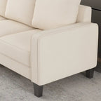 Canapé en tissu beige avec accoudoirs carrés et dossier capitonné
